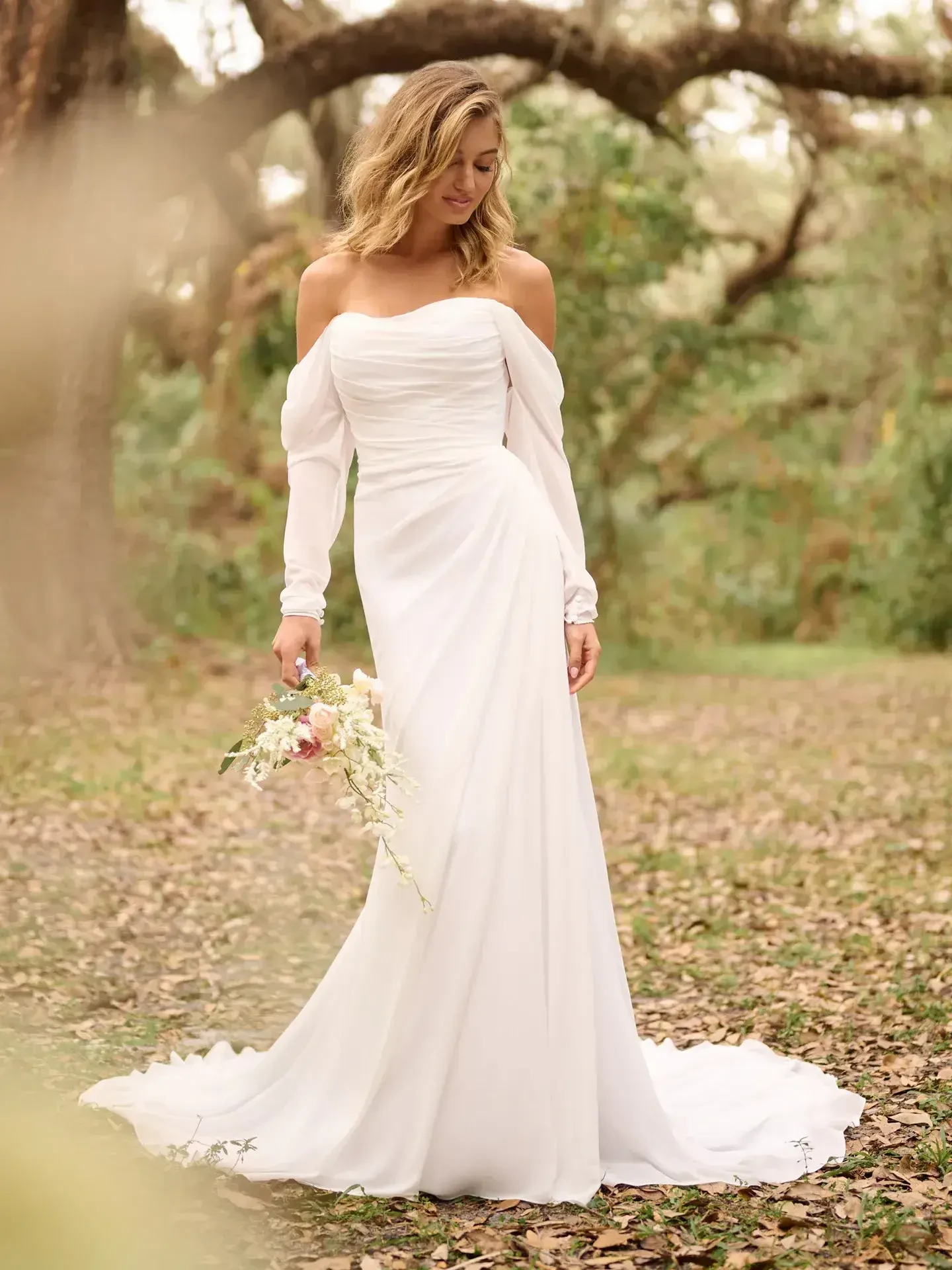 model is wearing a strapless fit and flare wedding dress