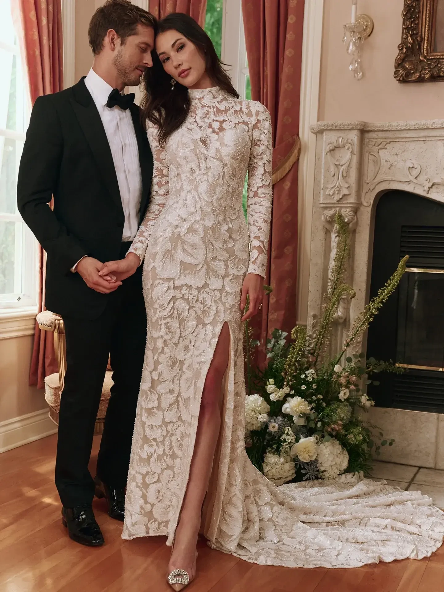 model is wearing a high neckline long sleeve sheath wedding dress