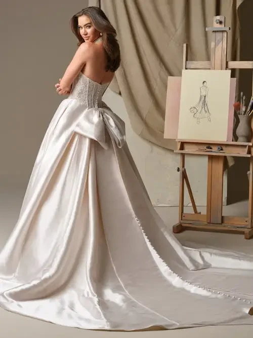 model is wearing a strapless ball gown wedding dress