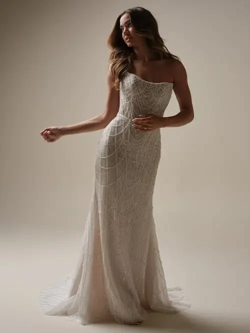 model is wearing a pearl strapless wedding gown