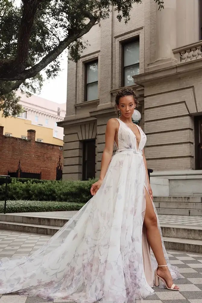 Model is wearing an a-line wedding gown with purple pastel floral printed tulle 