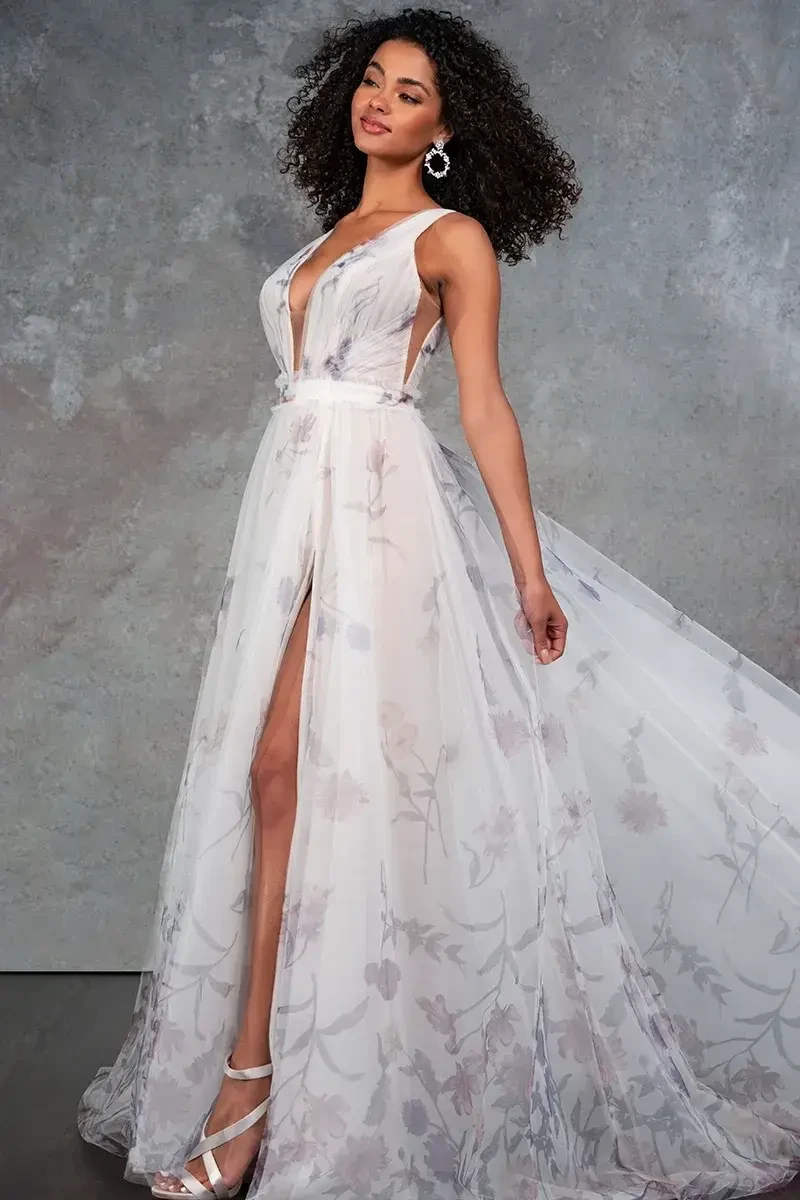 Model is wearing a pastel floral printed tulle a-line wedding dress with a flowy skirt