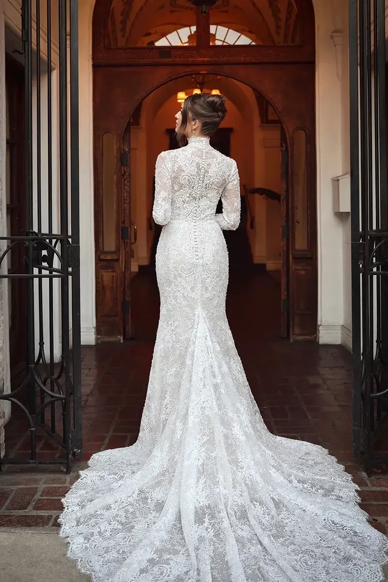 model is wearing a high neckline long sleeve wedding dress