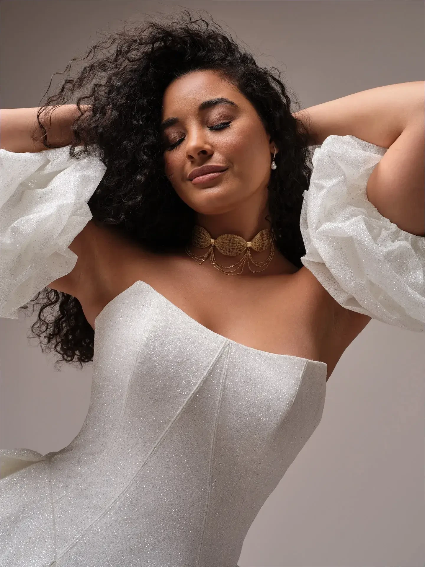  Model is wearing a voluminous sparkly regal ballgown wedding dress