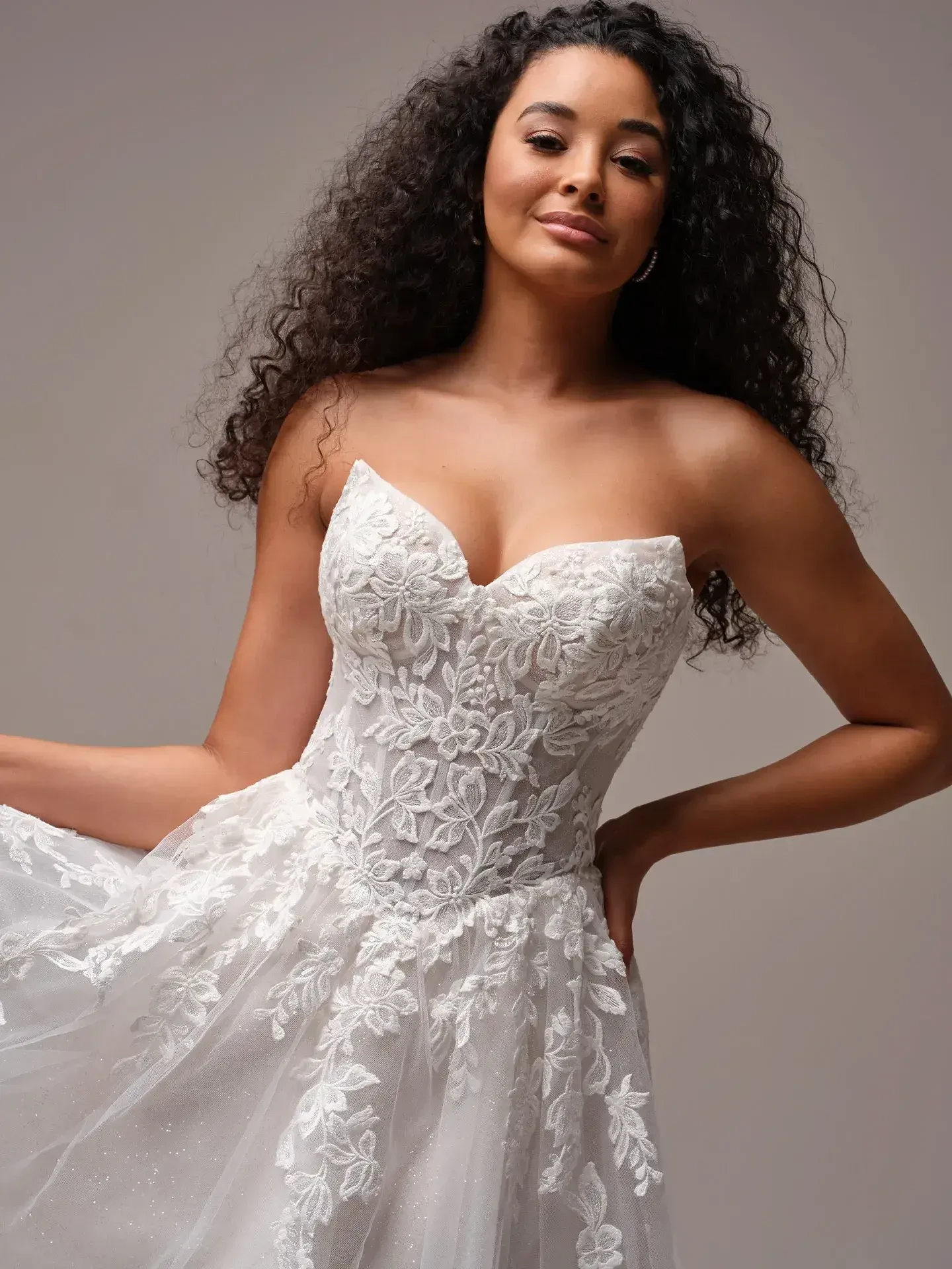  Model is wearing a strapless basque waist sequin A-line wedding dress with detachable off the shoulder straps